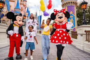 Family enjoying a magical day with Disney characters in front of Cinderella Castle at Walt Disney World in Orlando