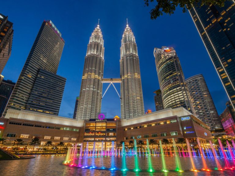 Affordable shopping mall in Kuala Lumpur with colorful stores and travelers